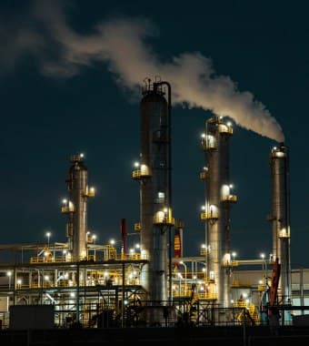 Process towers of a refinery lit at night